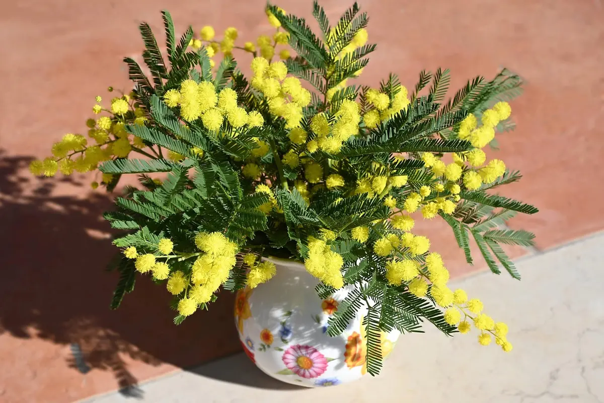 Arrangement floral printanier avec branches et fleurs fraîches dans un vase